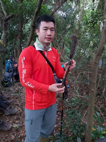 Hiking guide holding a knife
